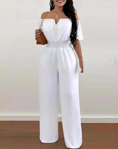 Woman wearing off-shoulder casual plain short sleeve wide leg jumpsuit for spring 2025
